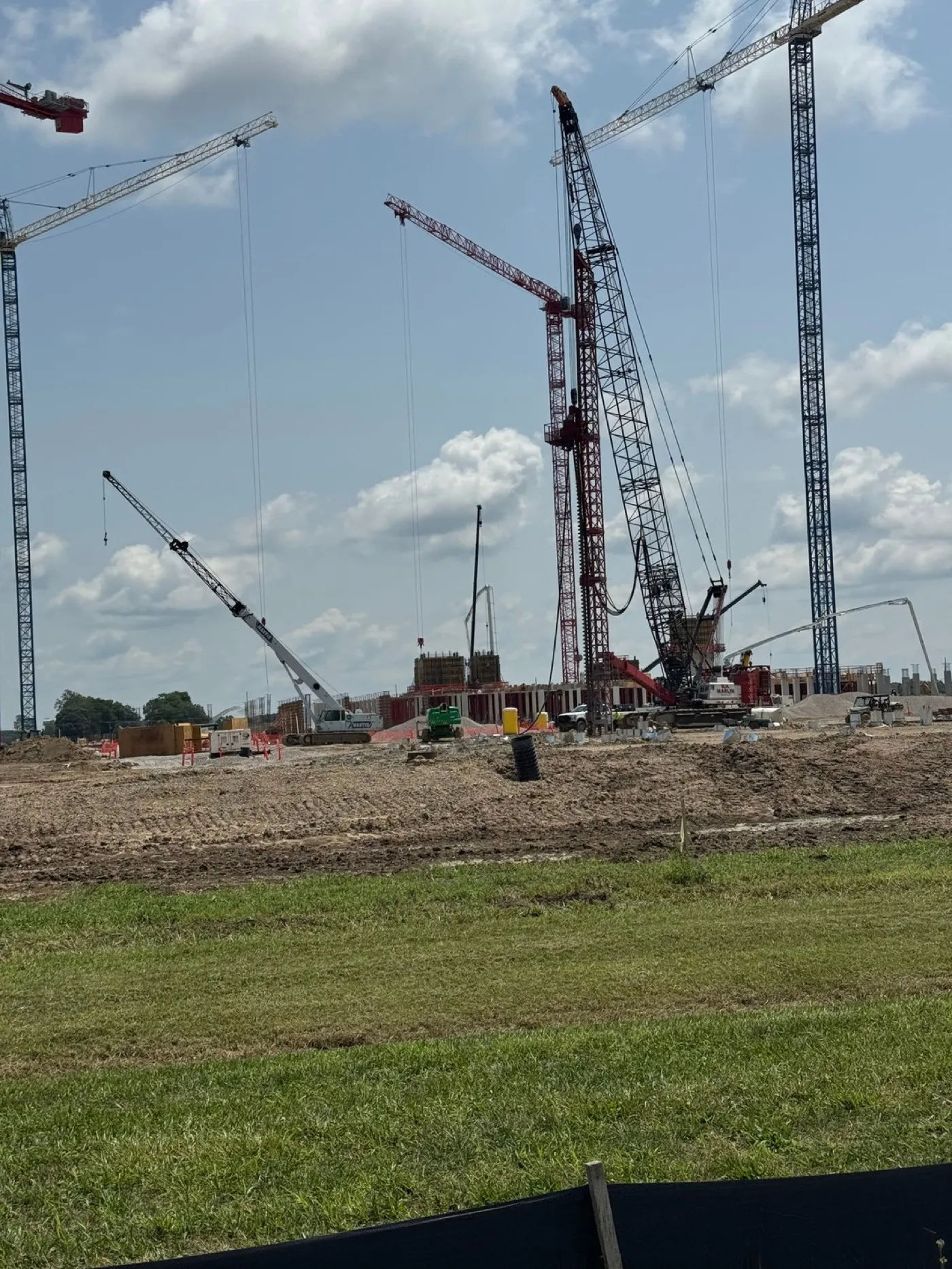 Tower cranes over a semiconductor facility under construction.