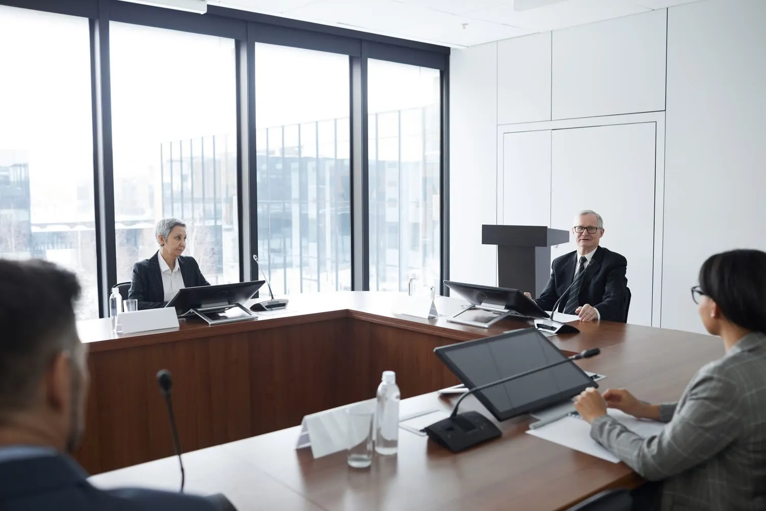 Senior leaders meeting in a boardroom with a city view